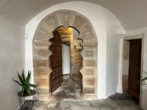 an archway with a wooden door in a building at Le vieux colombier in Le Monastier sur Gazeille +17 photos