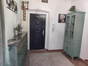 a hallway with a black door and a cabinet at Elena & Leila in Santa Maria a Monte