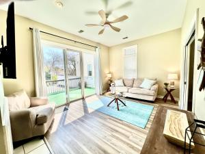 a living room with a couch and a ceiling fan at Downtown, Roof Deck, Parking in Saugatuck