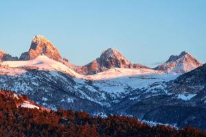 a view of a mountain range with snow covered mountains at Vibrant Spacious Ski Pad Hot Tubs in Driggs
