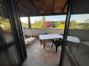 a room with a table and chairs on a balcony at La Piana Di Calena in Peschici