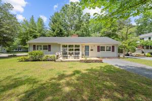 a home with a yard and a house at New Owners! Downtown Corner Cottage-Pet Friendly in Southern Pines
