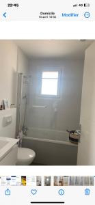 a bathroom with a white toilet and a window at Chambre d'hôtes Villas du Plantier in Andernos-les-Bains