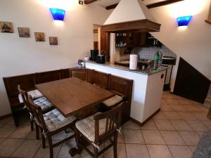 a kitchen with a dining room table and a counter at Naturstein-Rustiko Casa Marie in Vercana