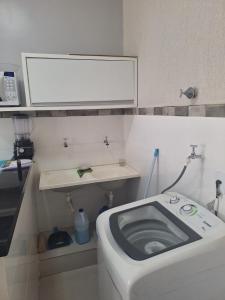 a small bathroom with a toilet and a sink at Apartamento vest unirv in Rio Verde