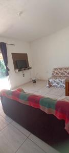 a room with two beds and a flat screen tv at Rancho Recanto Verde in Capitólio