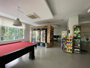 a billiard room with a red pool table in a store at 20 floor perfect view Brooklin in Sao Paulo