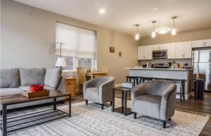a living room with a couch and chairs and a kitchen at Unit 32 Stylish 1BR 1BA Apartment Long-term stays in Chelsea +13 photos