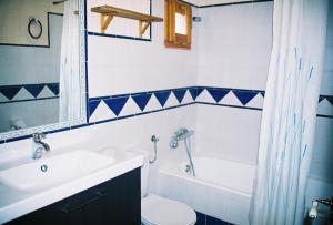 a bathroom with a sink and a toilet and a tub at Casa Chaparrete in Deza +5 photos
