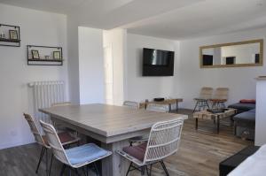 a living room with a wooden table and chairs at LedouxLand House near Disney in Bailly-Romainvilliers
