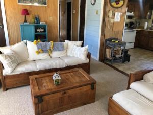 a living room with a couch and a coffee table at Captain's Quarters in Avon