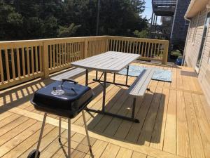 a picnic table and a bench on a deck at Captain's Quarters in Avon