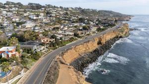 an aerial view of a road next to the ocean at Oceanfront Luxury Home Sunset Views in San Diego +84 photos