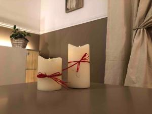 two white candles with red bows on a table at Studette proche Meaux-Disneyland-A4 in Saint-Jean-les-Deux-Jumeaux +21 photos