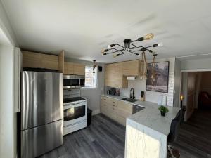 a kitchen with stainless steel appliances and wooden cabinets at Panache Royale 4 in Quebec City