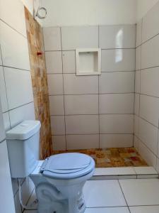 a bathroom with a toilet and a shower at Microcasa 1 - Centro Maricá in Maricá