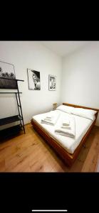a bedroom with a large bed with white sheets at Vienna Prater Apartment in Vienna