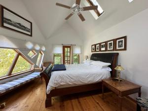 a bedroom with a bed and a ceiling fan at A River Runs Through It in East Branch