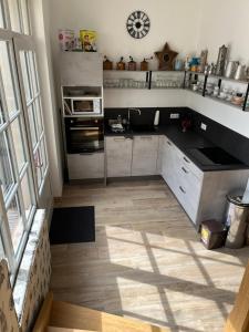 a kitchen with a stove and a microwave at Gîte Villa Santina in Piquecos