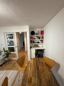 a living room with a wooden table and a desk at Spacious New London Apartment! in London