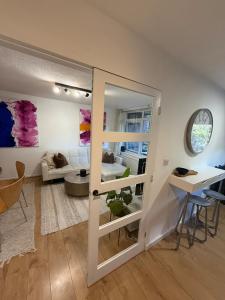 a living room with a door open to a living room at Spacious New London Apartment! in London