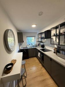 a kitchen with a table and a counter top at Spacious New London Apartment! in London
