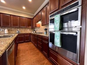 a kitchen with wooden cabinets and stainless steel appliances at One Story Pet & Family Friendly Fireplace in West Sacramento