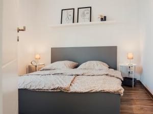 a bedroom with a large bed with two pillows at CBlue "Zickerstuuv", Wasserblick, in der Natur, Grill in Groß Zicker