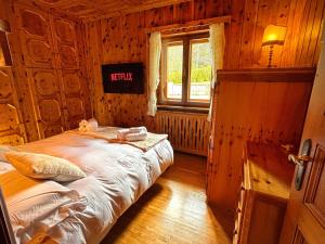 a bedroom with a bed in a log cabin at Exclusive Central Chalet, 5 min Sky Slopes, Garage in Cortina dʼAmpezzo