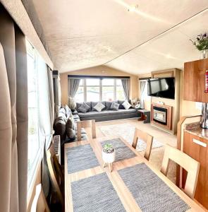 a living room with a table and a couch at 3 Bedroom 8 birth Caravan - Sand Le Mere in Tunstall +13 photos