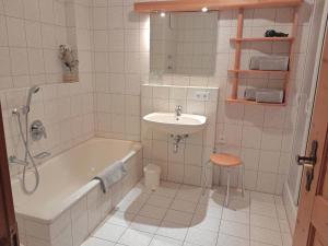 a bathroom with a sink and a bath tub and a sink at Bauernhof Landsamer in Aschau im Chiemgau +44 photos