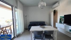 a living room with a white table and chairs at Stella del Mare in Silvi Marina