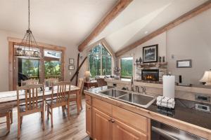a kitchen and dining room with a sink and a table at Lakota Lookout private hot tub in Winter Park