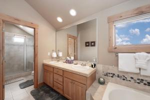 a bathroom with two sinks and a shower at Lakota Lookout private hot tub in Winter Park +33 photos
