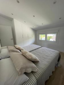 a bedroom with two beds with pillows on them at Casa Galbán in Vilagarcia de Arousa