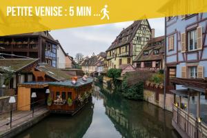 a view of a river with buildings and a city at Bretzel Bed Petite Venise Bed in Shared room City Center Wi-Fi in Colmar +21 photos
