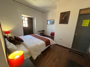 Postel nebo postele na pokoji v ubytování Mallku Wasi - Lodging Hotel Cusco