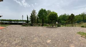 a stone patio with a picnic table in a park at Podere Piccini with pool in Val d'Orcia-Tuscany in Piancastagnaio