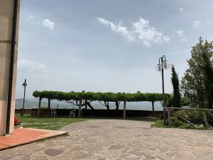 a pavilion with a view of the water in a park at Podere Piccini with pool in Val d'Orcia-Tuscany in Piancastagnaio