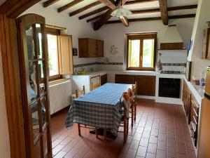 a kitchen with a table with a table cloth on it at Podere Piccini with pool in Val d'Orcia-Tuscany in Piancastagnaio