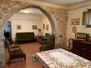 a room with a bed and a living room at Podere Piccini with pool in Val d'Orcia-Tuscany in Piancastagnaio
