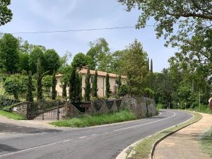a house on the side of a road at Podere Piccini with pool in Val d'Orcia-Tuscany in Piancastagnaio