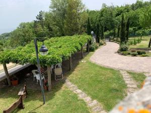 a garden with a street light and a row of plants at Podere Piccini with pool in Val d'Orcia-Tuscany in Piancastagnaio