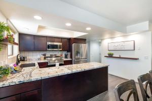a large kitchen with a large counter top and appliances at Happy Trails Flagstaff in Flagstaff