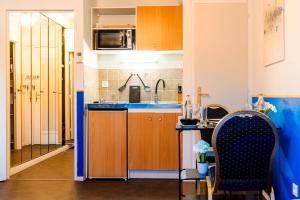 Η κουζίνα ή μικρή κουζίνα στο Home Suite Metz & Place de parking privée - Appartement Prestige +32 φωτογραφίες