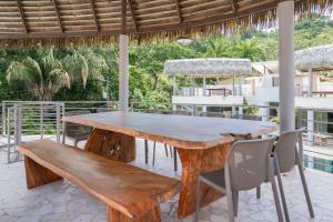 a wooden table and chairs on a patio at Hermosa Waves A2 in Playa Hermosa