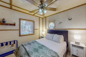 a bedroom with a bed and a ceiling fan at Catfish Cottage A in Eagle River