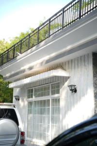 a house with a balcony on top of it at Ariston Suites in Islamabad