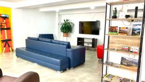 a living room with a blue couch and a tv at CasaColibri in Pasto