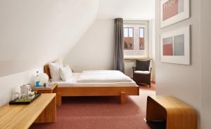 Postel nebo postele na pokoji v ubytování Hotel an der Marienkirche